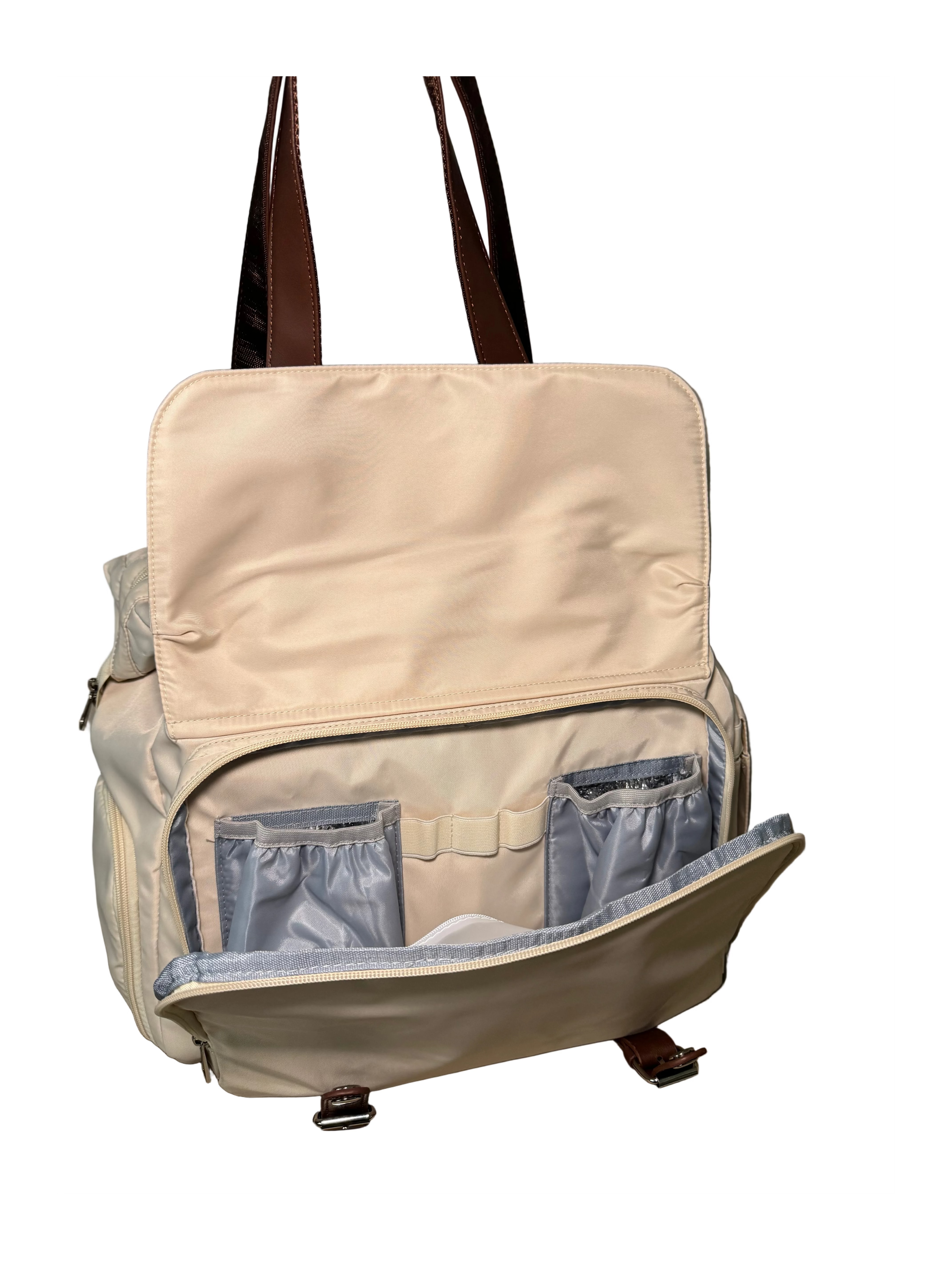 Beige backpack with brown straps on a beige couch